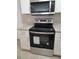 Kitchen features stainless steel appliances, granite counters, and white cabinets at 4307 Bayside Village Dr # 103, Tampa, FL 33615
