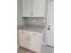 White cabinets and granite countertops next to a door at 4307 Bayside Village Dr # 103, Tampa, FL 33615