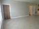 Open and airy living space with tile floors, neutral walls, and a sliding glass door at 4307 Bayside Village Dr # 103, Tampa, FL 33615
