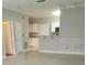 Open-concept layout combining living room with white cabinets and an eat-in kitchen bar at 4307 Bayside Village Dr # 103, Tampa, FL 33615