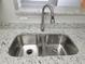 Close up of kitchen double sink, granite counters, and stainless steel faucet at 4307 Bayside Village Dr # 103, Tampa, FL 33615