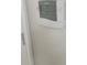 Mounted digital thermostat with 77 degrees showing on display at 4307 Bayside Village Dr # 103, Tampa, FL 33615