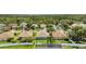 Aerial view of a backyard with fence, a patio, and some trees at 5145 Prairie View Way, Wesley Chapel, FL 33545