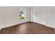 Bright bedroom with hardwood floors, closet, and a window with neighborhood views at 5145 Prairie View Way, Wesley Chapel, FL 33545