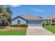 Charming blue single-story home with a well-manicured lawn and a two-car garage at 5145 Prairie View Way, Wesley Chapel, FL 33545