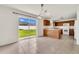 A bright kitchen with wood cabinets and white appliances has access to the backyard at 5145 Prairie View Way, Wesley Chapel, FL 33545