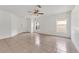 Bright living room with tile floors, a ceiling fan, and lots of natural light from the windows at 5145 Prairie View Way, Wesley Chapel, FL 33545