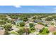 Aerial view of a residential neighborhood with mature trees and well-maintained lawns at 5145 Prairie View Way, Wesley Chapel, FL 33545