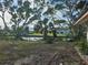 View of the backyard with waterfront access and lush tropical landscaping at 801 Marlin Dr, Punta Gorda, FL 33950