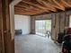 Interior of a living room, in the middle of renovation, with a fireplace and sliding glass doors at 801 Marlin Dr, Punta Gorda, FL 33950