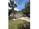Home featuring a fenced yard with mature palm trees and lawn at 9504 W Cluster Ave, Tampa, FL 33615