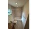 Clean bathroom with a tiled shower, modern fixtures, and ample natural light at 9504 W Cluster Ave, Tampa, FL 33615