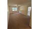 Well-lit bedroom with carpet, ceiling fan, and a window providing natural light at 9504 W Cluster Ave, Tampa, FL 33615