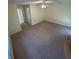 Spacious bedroom with a ceiling fan, neutral walls and carpets at 9504 W Cluster Ave, Tampa, FL 33615