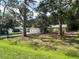 A charming home with a well-manicured lawn and mature trees at 9504 W Cluster Ave, Tampa, FL 33615