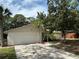 Traditional single-story home featuring a two-car garage and well-maintained lawn at 9504 W Cluster Ave, Tampa, FL 33615