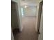 View through hallway with door openings into carpeted bedroom at 9504 W Cluster Ave, Tampa, FL 33615