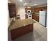 Bright kitchen featuring granite countertops, stainless steel appliances, and plenty of storage space at 9504 W Cluster Ave, Tampa, FL 33615