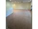 Spacious living room featuring neutral walls, carpet flooring, and a ceiling fan at 9504 W Cluster Ave, Tampa, FL 33615