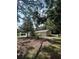 Home showing a mature tree and manicured flower beds at 9504 W Cluster Ave, Tampa, FL 33615