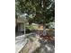 Picture shows a home and side yard with mature landscaping at 9504 W Cluster Ave, Tampa, FL 33615