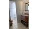 Modern bathroom with brown vanity with baskets and decorative tile accents at 1409 Yorkshire St, Port Charlotte, FL 33952