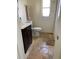Bright bathroom with a dark vanity, toilet, shower and stone-look tile floors at 1409 Yorkshire St, Port Charlotte, FL 33952