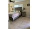 Bedroom with ceiling fan, bedside lamps, and a gray wood-look bed frame at 1409 Yorkshire St, Port Charlotte, FL 33952