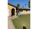 Single-story home with a well-maintained lawn, neutral paint, and welcoming arched entryway at 1409 Yorkshire St, Port Charlotte, FL 33952
