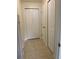 Hallway with off-white walls and trim with three white closets in the hallway at 1409 Yorkshire St, Port Charlotte, FL 33952