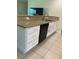 Kitchen area featuring a granite countertop and black dishwasher and drawers at 1409 Yorkshire St, Port Charlotte, FL 33952