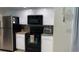 Galley kitchen with granite countertops, stainless steel appliances, and white cabinets at 1409 Yorkshire St, Port Charlotte, FL 33952
