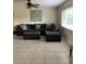 Comfortable living room featuring a large sectional sofa, ottoman, and a decorative piece of artwork at 1409 Yorkshire St, Port Charlotte, FL 33952