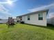 Spacious backyard with lush green grass and play structure, perfect for outdoor activities and Gathering fun at 3567 74Th Avenue E Cir, Sarasota, FL 34243