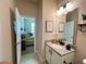 Charming bathroom with granite countertop, modern fixtures, and a glimpse of the adjacent bedroom at 3567 74Th Avenue E Cir, Sarasota, FL 34243