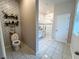 Well-maintained bathroom with updated fixtures, decorative wallpaper, and tiled floors at 3567 74Th Avenue E Cir, Sarasota, FL 34243