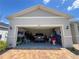 Spacious two-car garage with ample storage space and modern vehicle parked inside, promising convenience at 3567 74Th Avenue E Cir, Sarasota, FL 34243