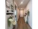 Inviting hallway featuring stylish decor, wood flooring, and natural light at 3567 74Th Avenue E Cir, Sarasota, FL 34243