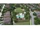 Aerial view of the community's pool surrounded by lush greenery and beautiful homes, perfect for Gathering enjoyment at 12990 Burns Dr, Odessa, FL 33556