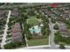 Aerial view of the community's pool and playground surrounded by lush greenery and beautiful homes, perfect for Gathering enjoyment at 12990 Burns Dr, Odessa, FL 33556
