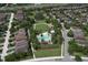 Aerial view of the community's pool and playground surrounded by lush greenery and beautiful homes, perfect for Gathering enjoyment at 12990 Burns Dr, Odessa, FL 33556