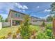Home backyard featuring extended patio with a grass lawn and landscaping at 12990 Burns Dr, Odessa, FL 33556