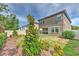 Landscaped backyard featuring a lawn, mulch beds, and view of the home's back patio at 12990 Burns Dr, Odessa, FL 33556