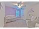 This Bedroom features a white crib, a cozy armchair, and calming decor for a serene atmosphere at 12990 Burns Dr, Odessa, FL 33556