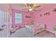 This playful bedroom offers a ceiling fan, whimsical decor, and lots of space for toys and imagination at 12990 Burns Dr, Odessa, FL 33556