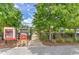 Inviting community entrance featuring a colorful library, lush trees, and a serene walkway at 12990 Burns Dr, Odessa, FL 33556