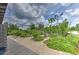 Inviting community garden featuring raised beds, lush plants, and a charming windmill at 12990 Burns Dr, Odessa, FL 33556