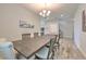 Dining area features a wooden table, neutral walls, and stylish hanging light fixture at 12990 Burns Dr, Odessa, FL 33556