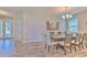 Dining room featuring stylish tile floors, bright windows, and a modern chandelier at 12990 Burns Dr, Odessa, FL 33556