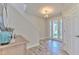 Bright foyer with decorative glass front door, tile flooring, and staircase at 12990 Burns Dr, Odessa, FL 33556